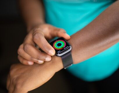 person wearing silver aluminum case apple watch with white sport band