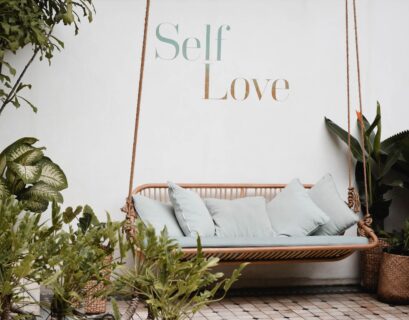 brown rattan swing bench with cushions