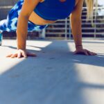 woman planking on gray asphalt road