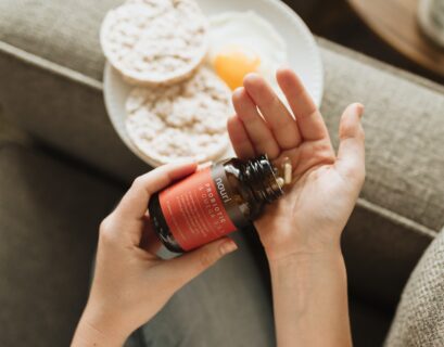 person holding red bottle