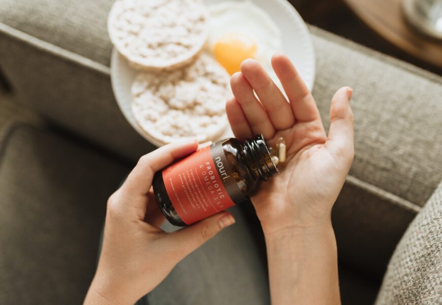 person holding red bottle