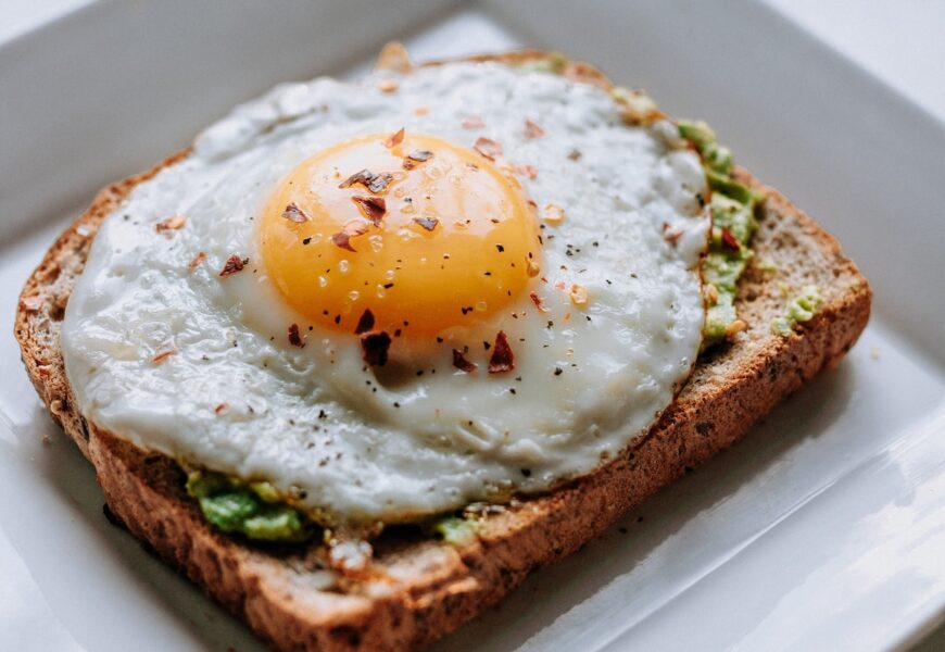 bread with sunny side-up egg served on white ceramic plate