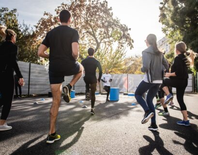 man in black t-shirt and black shorts running on road during daytime