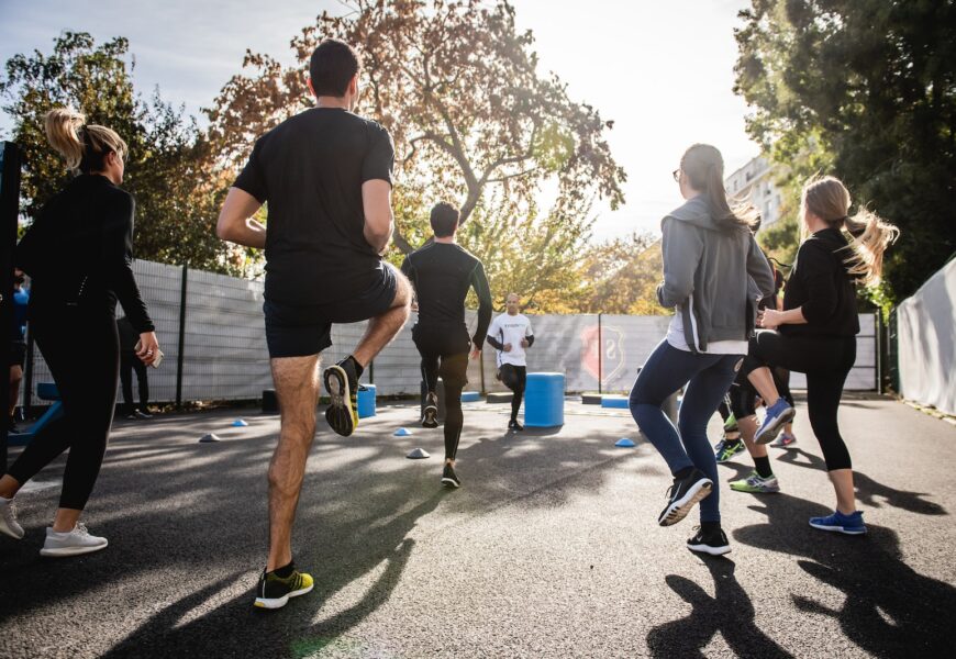 man in black t-shirt and black shorts running on road during daytime