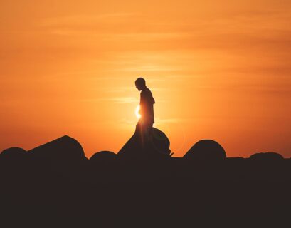 person standing on rock platform