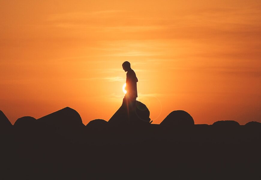 person standing on rock platform