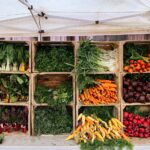 a variety of vegetables are displayed in wooden crates