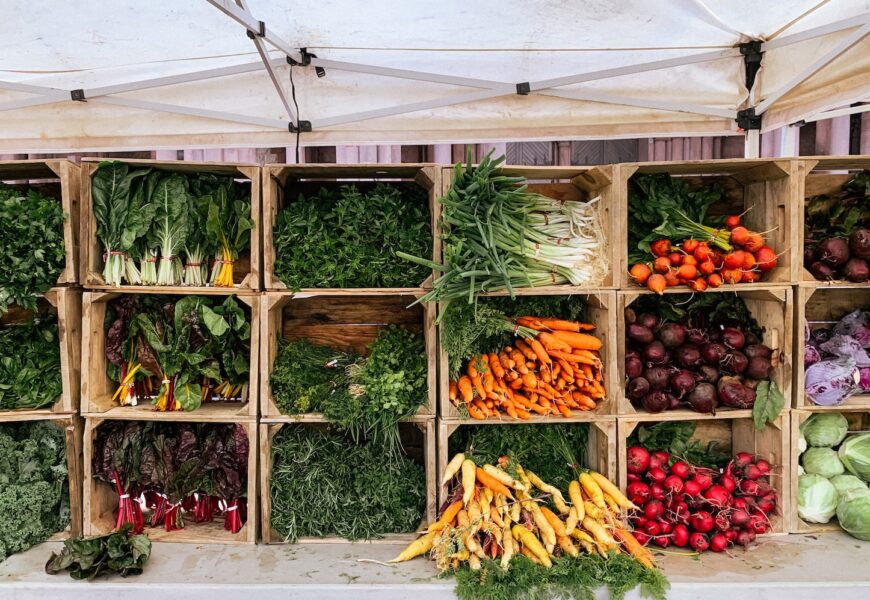 a variety of vegetables are displayed in wooden crates