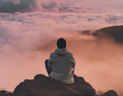 man sitting on cliff