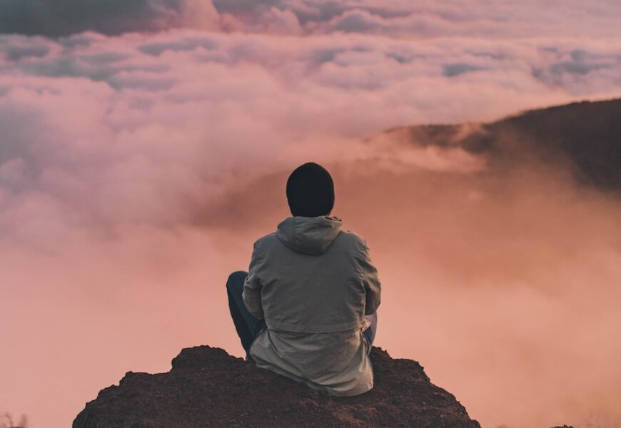 man sitting on cliff