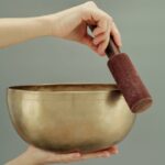 person holding brown clay pot