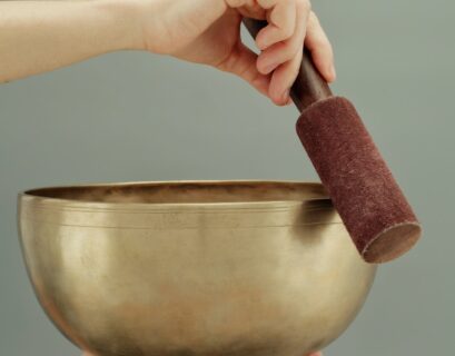 person holding brown clay pot